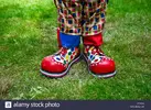 close-up-of-a-clowns-boots-and-trousers-CF2GYJ.webp