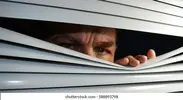 face-behind-blinds-260nw-588893798.webp