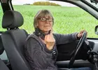 senior-woman-in-the-car-shows-middle-finger.webp