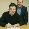 a terrible picture of Jack Grealish signing the co.webp
