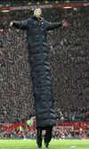 Arsene-Wengers-coat-gets-bigger-every-day.webp
